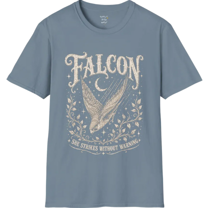 A grunge tee with an illustrated falcon wing design, crescent moon, and botanical linework, text reading "Falcon" and "She Strikes Without Warning" — Wild Animals collection by Ramro Yoga Wear in Stone Blue.