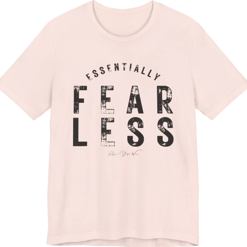 A typographic grunge tee reading "Essentially Fear Less" in bold block lettering — Funny Yoga Shirts collection by Ramro Yoga Wear in Soft Pink.