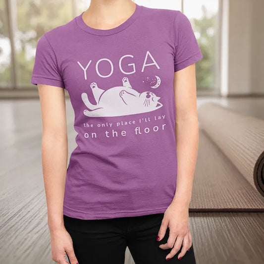 Floor T-Shirt Lifestyle 2 showing woman in purple tee with cat yoga design, soft studio setting highlighting comfort and humor.