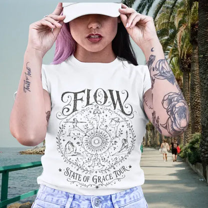 Flow T-Shirt White shown on model beside coastal palm walkway with relaxed boho styling.