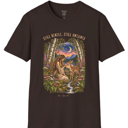 A short sleeved tee called the Gentle T-Shirt, flat lay and a Gildan 64000 shirt. Simply says, Still Gentle, Still Untamed. Design highlights a woman with wildflowers in her hair kneeling in a birch forest, gently cupping the chin of a spotted fawn, with foxgloves, ferns and a small stream below a crescent moon at twilight, in a full-color painted illustration style. Color is Dark Chocolate.