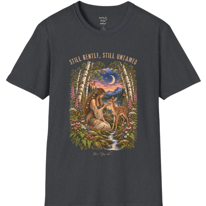A short sleeved tee called the Gentle T-Shirt, flat lay and a Gildan 64000 shirt. Simply says, Still Gentle, Still Untamed. Design highlights a woman with wildflowers in her hair kneeling in a birch forest, gently cupping the chin of a spotted fawn, with foxgloves, ferns and a small stream below a crescent moon at twilight, in a full-color painted illustration style. Color is Dark Heather Grey.