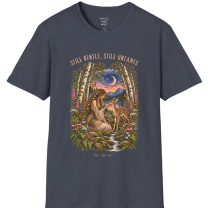 A short sleeved tee called the Gentle T-Shirt, flat lay and a Gildan 64000 shirt. Simply says, Still Gentle, Still Untamed. Design highlights a woman with wildflowers in her hair kneeling in a birch forest, gently cupping the chin of a spotted fawn, with foxgloves, ferns and a small stream below a crescent moon at twilight, in a full-color painted illustration style. Color is Heather Navy.