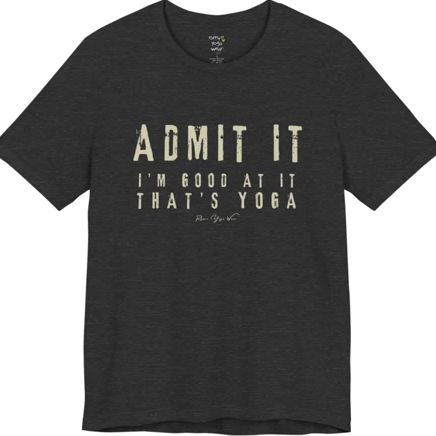 A short sleeved tee called the Good T-Shirt, flat lay and a Bella+Canvas 3001 shirt. Simply says, Admit It, I'm Good At It, That's Yoga. Design highlights bold distressed cream lettering with ADMIT IT large above two smaller lines of wide-spaced text. Color is Dark Grey Heather.