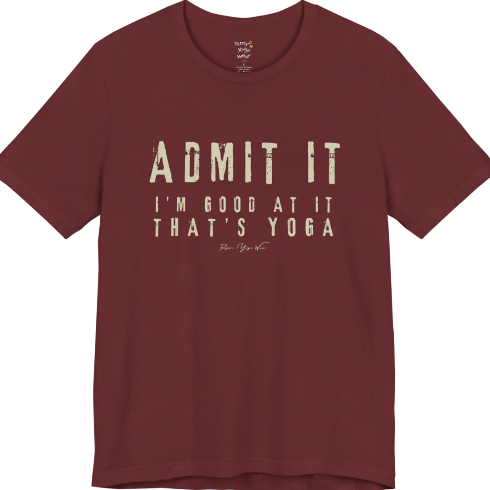 A short sleeved tee called the Good T-Shirt, flat lay and a Bella+Canvas 3001 shirt. Simply says, Admit It, I'm Good At It, That's Yoga. Design highlights bold distressed cream lettering with ADMIT IT large above two smaller lines of wide-spaced text. Color is Heather Cardinal.