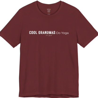 A short sleeved tee called the Grandmas T-Shirt, flat lay and a soft cotton blend shirt. Simply says, Cool Grandmas Do Yoga. Design highlights bold distressed block lettering for COOL GRANDMAS beside thin lettering for Do Yoga, with a small script signature underneath. Color is Heather Cardinal.