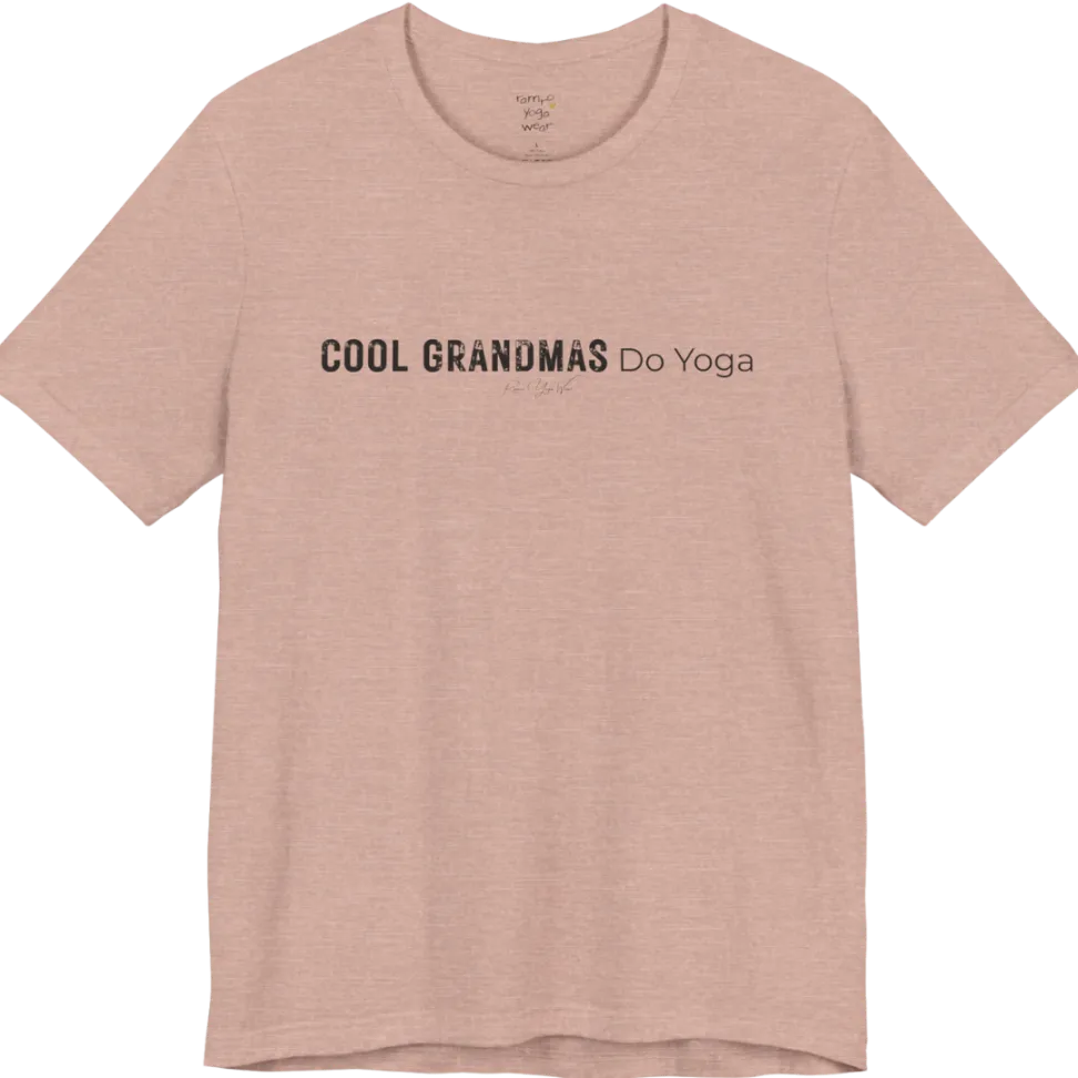 A short sleeved tee called the Grandmas T-Shirt, flat lay and a soft cotton blend shirt. Simply says, Cool Grandmas Do Yoga. Design highlights bold distressed block lettering for COOL GRANDMAS beside thin lettering for Do Yoga, with a small script signature underneath. Color is Heather Prism Peach.