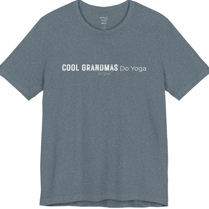 A short sleeved tee called the Grandmas T-Shirt, flat lay and a soft cotton blend shirt. Simply says, Cool Grandmas Do Yoga. Design highlights bold distressed block lettering for COOL GRANDMAS beside thin lettering for Do Yoga, with a small script signature underneath. Color is Heather Slate.