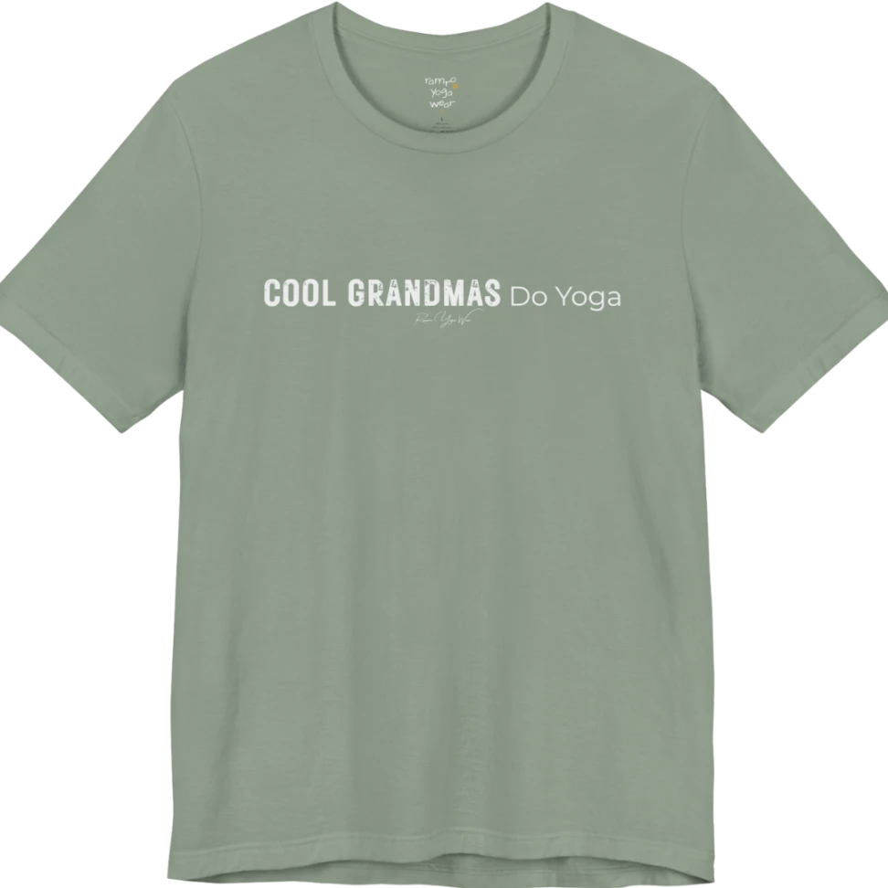 A short sleeved tee called the Grandmas T-Shirt, flat lay and a soft cotton blend shirt. Simply says, Cool Grandmas Do Yoga. Design highlights bold distressed block lettering for COOL GRANDMAS beside thin lettering for Do Yoga, with a small script signature underneath. Color is Sage. 