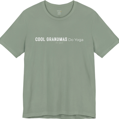 A short sleeved tee called the Grandmas T-Shirt, flat lay and a soft cotton blend shirt. Simply says, Cool Grandmas Do Yoga. Design highlights bold distressed block lettering for COOL GRANDMAS beside thin lettering for Do Yoga, with a small script signature underneath. Color is Sage. 