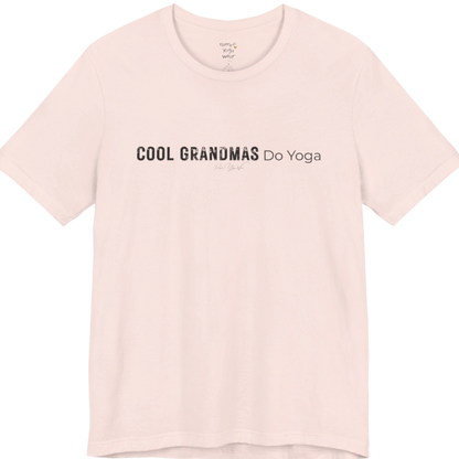 A short sleeved tee called the Grandmas T-Shirt, flat lay and a soft cotton blend shirt. Simply says, Cool Grandmas Do Yoga. Design highlights bold distressed block lettering for COOL GRANDMAS beside thin lettering for Do Yoga, with a small script signature underneath. Color is Soft Pink.