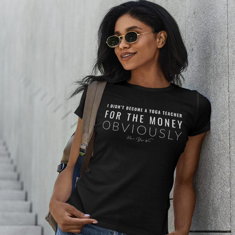 Woman wearing Guide Black yoga teacher gift tee against an urban concrete wall — Yoga Teacher Gifts collection by Ramro Yoga Wear