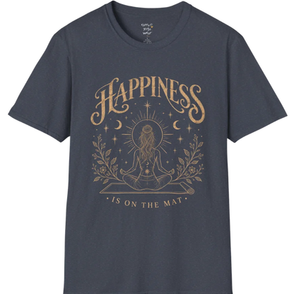 A short sleeved tee called the Happiness T-Shirt, flat lay and a soft cotton shirt. Simply says, Happiness is on the mat. Design highlights ornate warm gold HAPPINESS lettering above a figure meditating cross-legged on a yoga mat, seen from behind beneath a thin sun halo, with crescent moons, stars and botanical sprigs. Color is Heather Navy.