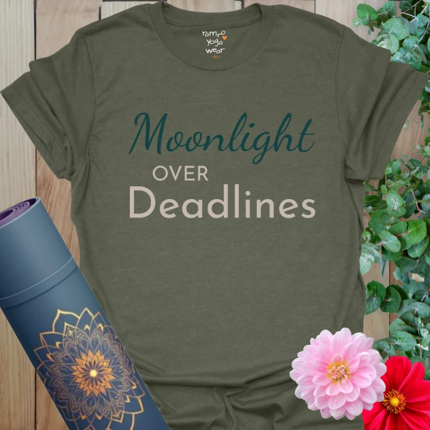 Heather Military Green tee with “Moonlight Over Deadlines” text in deep teal and sand. Yoga-inspired design for calm energy and soft strength.