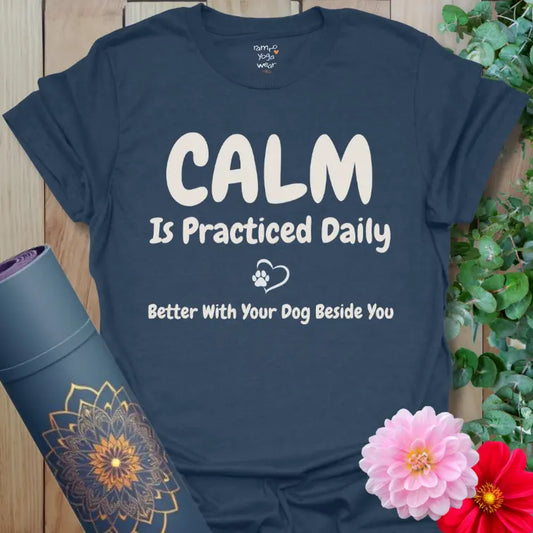 Heather Navy Practiced Daily T-Shirt featuring bold calm message and heart paw detail. Grounded yoga shirt with soulful comfort.