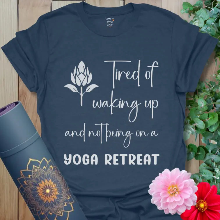 Heather Navy Yoga Retreat T-Shirt featuring bold “YOGA RETREAT” text and flowing script. Relaxed, travel-inspired yoga apparel.