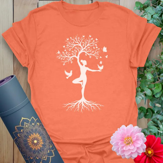 Heather orange yoga t-shirt with white tree pose and birds design symbolizing growth