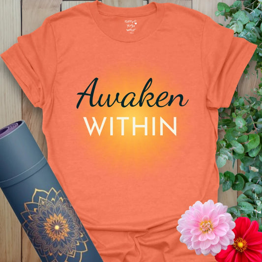 Heather Orange Awaken T-Shirt with sunrise burst and bold message. Vibrant yoga top for daily motivation and warm energy.