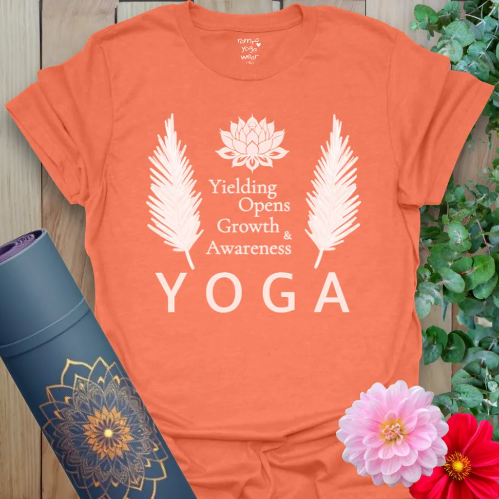 Heather orange t-shirt with acronym-style yoga design and floral accents