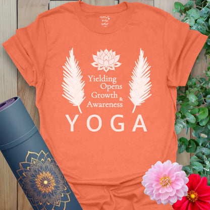 Heather orange t-shirt with acronym-style yoga design and floral accents