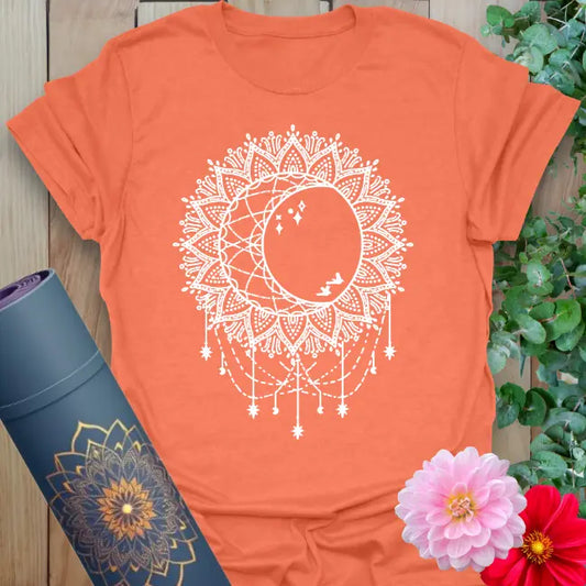 Heather orange celestial tee with sun, moon, and sacred geometry elements