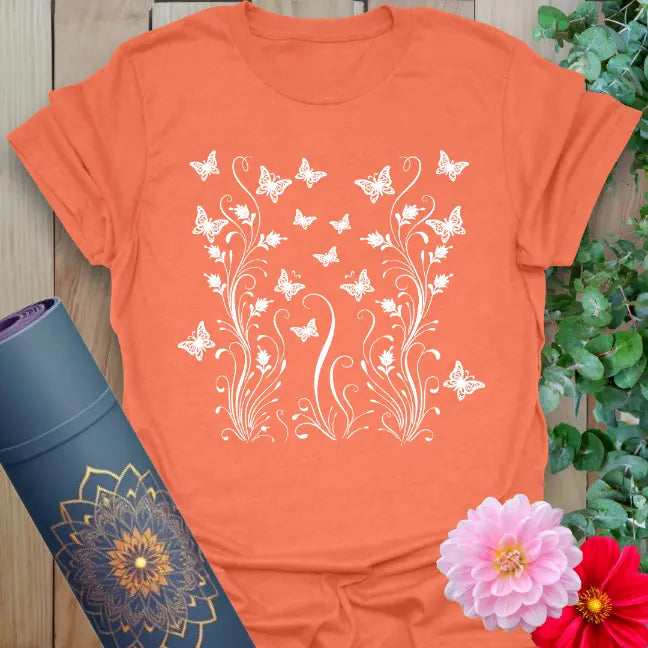 Heather orange yoga tee with uplifting butterfly and botanical graphic