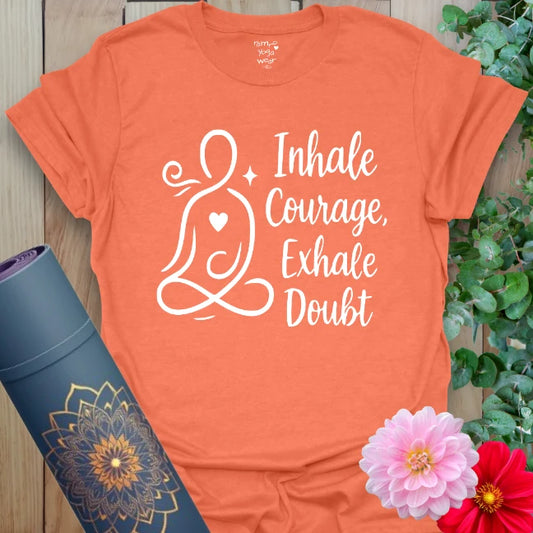 Heather orange t-shirt with bold "Inhale Courage, Exhale Doubt" affirmation and peaceful yoga art