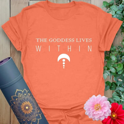 Vibrant orange yoga t-shirt showcasing empowering goddess affirmation and sacred symbol for soulful spiritual seekers.