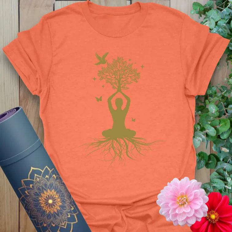 Vibrant orange yoga t-shirt showcasing grounded yogi growing into tree with butterflies for conscious, mindful movement.