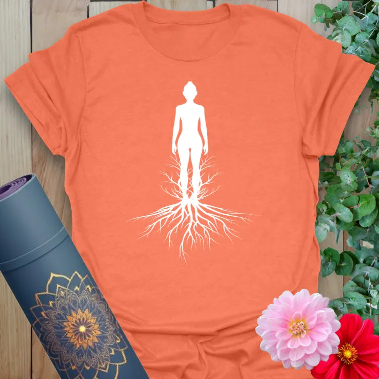 Vibrant orange yoga t-shirt showcasing soulful rooted silhouette artwork for conscious living and spiritual grounding.