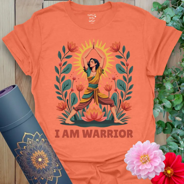 Vibrant orange yoga t-shirt showcasing colorful Warrior Pose illustration with lotus flowers and sunshine for strength and resilience.