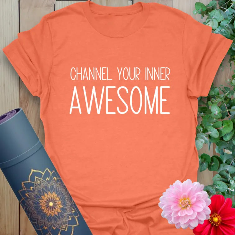Vibrant orange yoga t-shirt showcasing inspiring "Channel Your Inner Awesome" message for soulful positivity and growth.