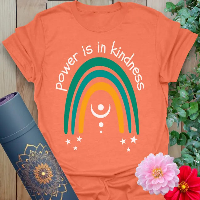 Vibrant orange yoga t-shirt showcasing uplifting rainbow and kindness quote perfect for conscious movement and positivity.