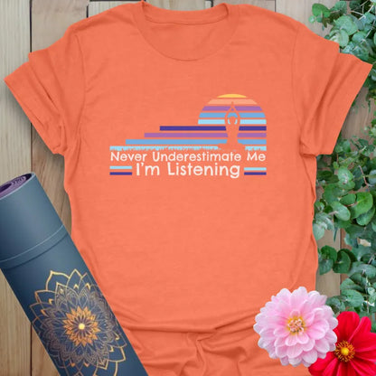 Vibrant orange yoga t-shirt showcasing colorful mindful listening design and strong soulful affirmation.