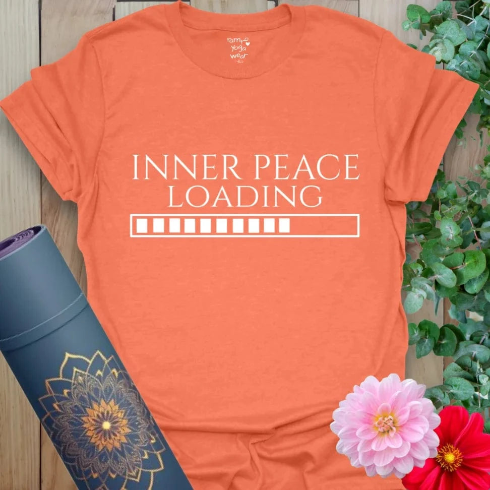 Bright orange t-shirt with humorous “Inner Peace Loading” message, perfect for mindful movement and everyday zen.