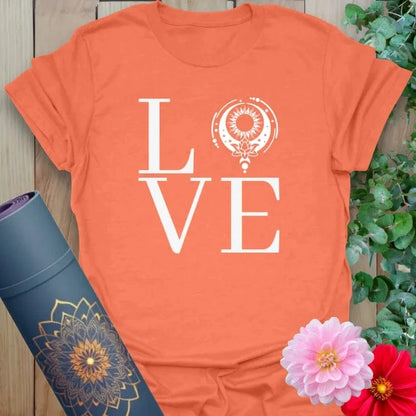 Vibrant orange yoga t-shirt showcasing spiritual "LOVE" design with mandala-inspired circle for soulful connection.