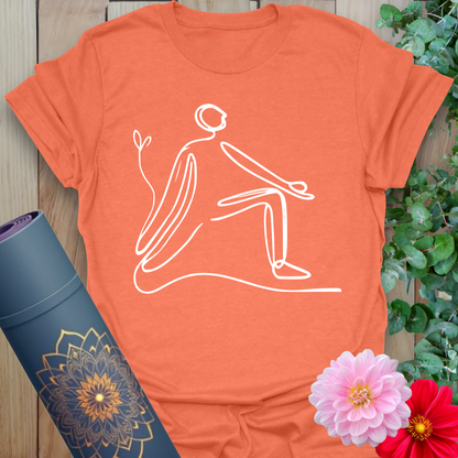 Vibrant orange yoga t-shirt showcasing elegant single-line lunge pose artwork for soulful, conscious flow.