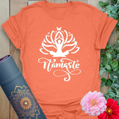 Vibrant orange yoga t-shirt showcasing sacred lotus and yogi design inspiring soulful grace and conscious living.