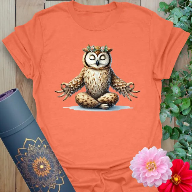 Vibrant orange yoga t-shirt showcasing peaceful owl meditation design symbolizing light-hearted wisdom and grounded joy.