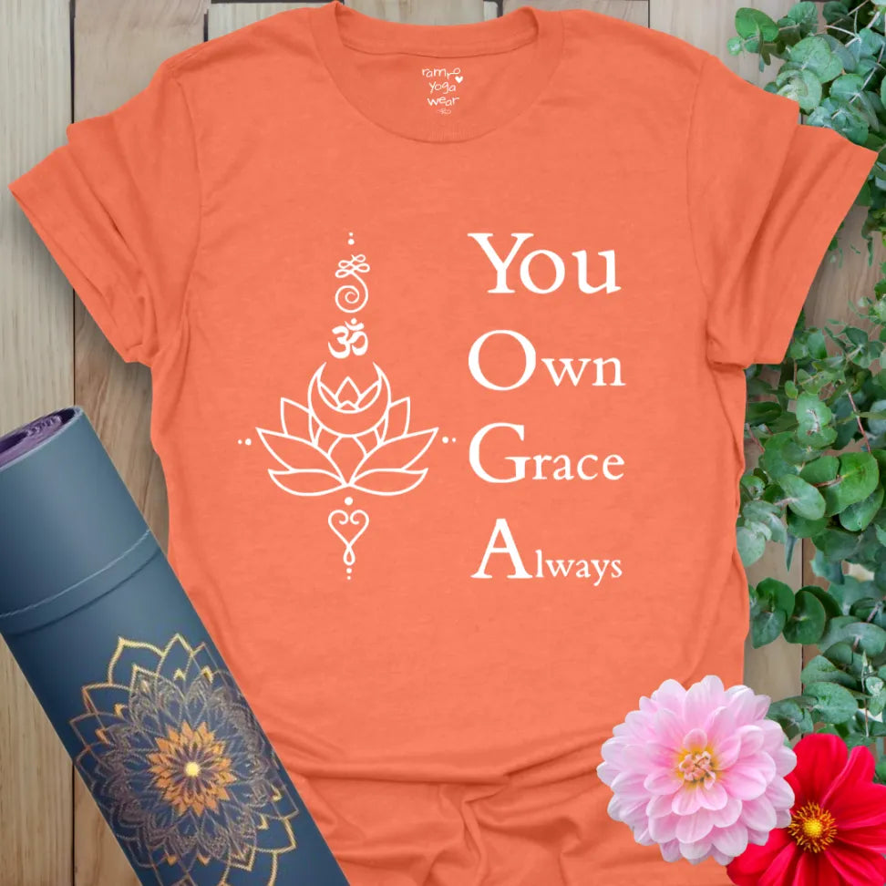 Vibrant orange yoga t-shirt showcasing spiritual symbols and empowering mantra promoting soulful, conscious living.