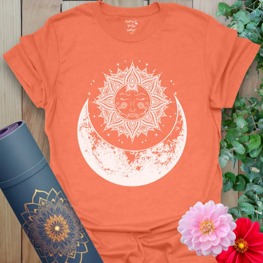 Vibrant orange yoga t-shirt showcasing mystical sun and moon artwork inspiring connection to natural cycles and inner light.