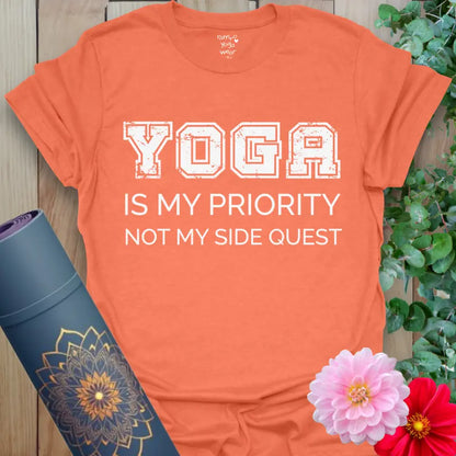 Heather Orange Priority T-Shirt featuring vibrant motivational lettering with a warm, energetic yoga vibe.