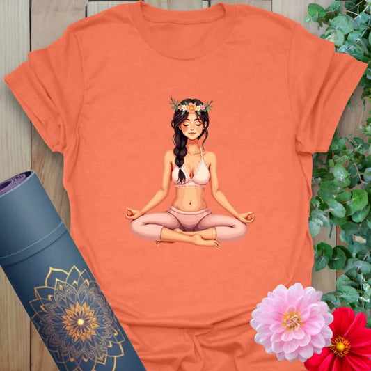 Vibrant orange yoga t-shirt showcasing peaceful yogi illustration with floral details inspiring inner calm and joyful presence.