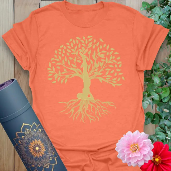 Vibrant orange yoga t-shirt showcasing tree of life shoulder stand yogi design symbolizing mindful growth and conscious living.