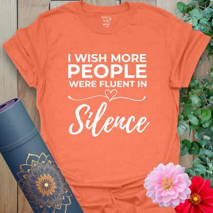Vibrant orange yoga t-shirt showcasing humorous and soulful silence affirmation inspiring mindful communication and presence.