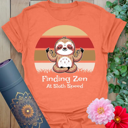 Vibrant orange yoga t-shirt showcasing chill sloth and mindfulness mantra inspiring conscious slow movement and joyful stillness.
