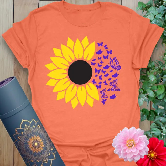 Vibrant orange t-shirt with blooming sunflower and butterfly design for spiritual joy and nature-inspired yoga wear.