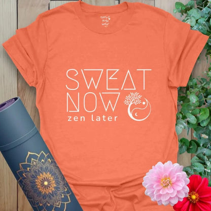 Heather Orange Sweat Now T-Shirt featuring empowering text “Sweat Now, Zen Later” with mandala symbol. Vibrant yoga gift for active souls.
