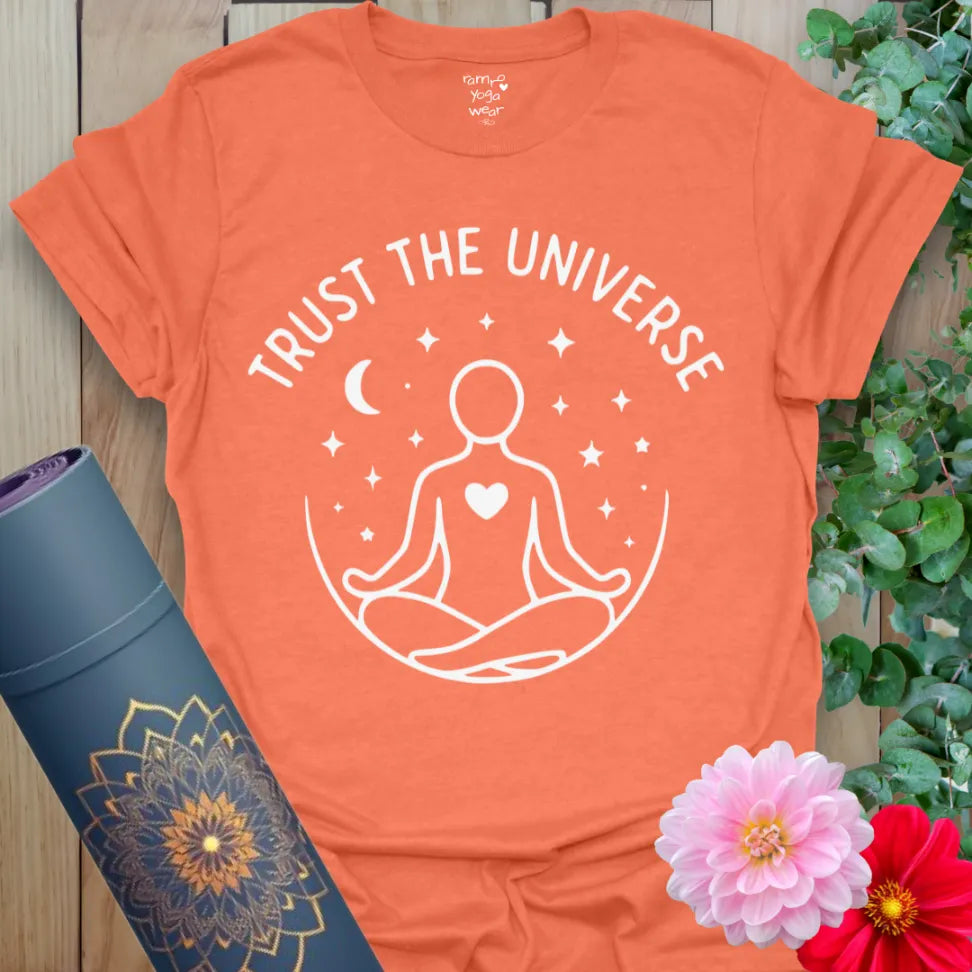 Vibrant orange t-shirt with meditating figure and starry night design for mindful surrender and spiritual expression.
