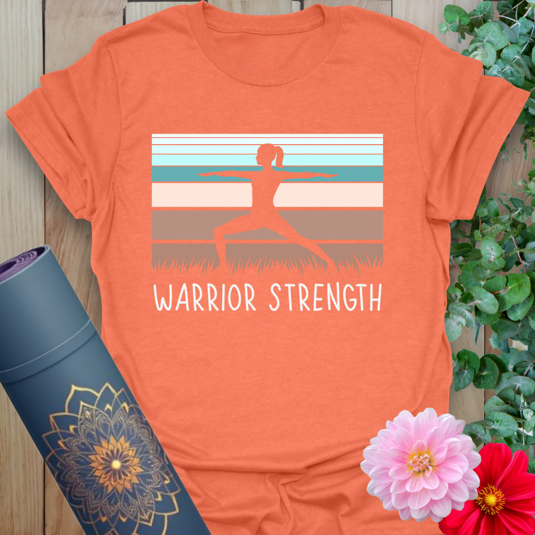 Vibrant orange t-shirt with bold yoga warrior pose and desert-toned backdrop for empowered mindful movement.